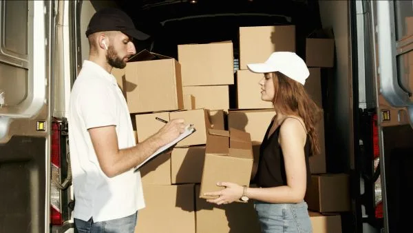 distributor packing boxes into a van